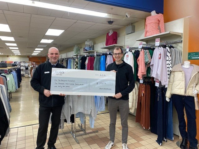 Lee Hodds, Bowthorpe store manager, presenting a check to Josh from the Benjamin Foundation